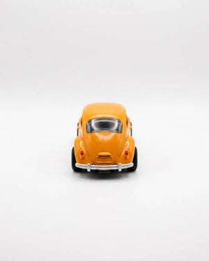 Volkswagen Beetle diecast model car toy, yellow-orange, close front view with grille