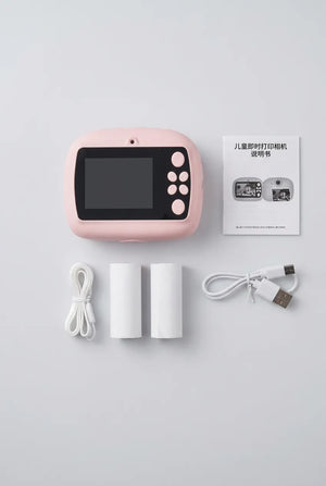 Packaging for the Pink kids instant print digital camera showing its rear screen and black-and-white photo print