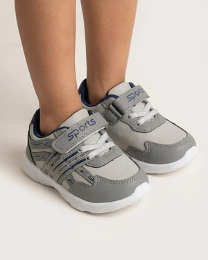 Black kids sports sneakers shown from above with adjustable straps