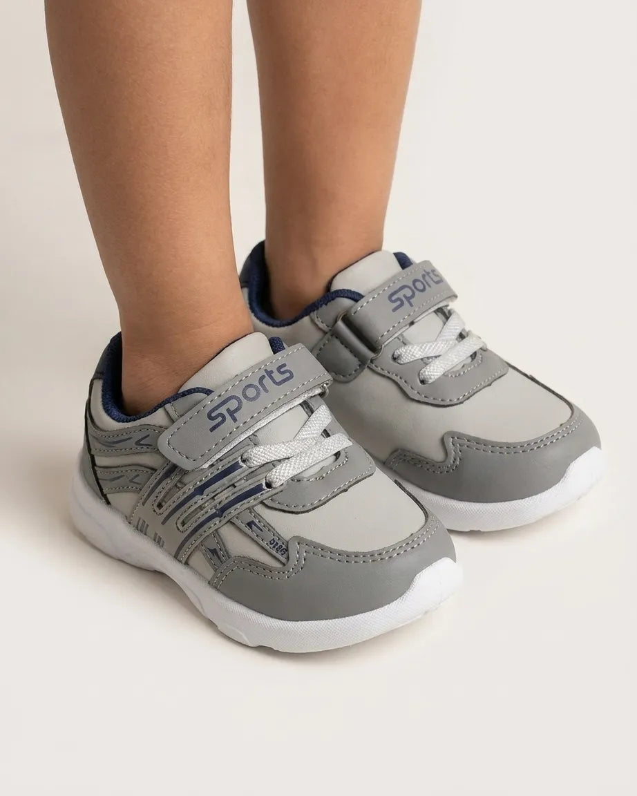 Black kids sports sneakers shown from above with adjustable straps