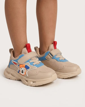 Beige kids cartoon chunky sneakers with blue accents worn on feet