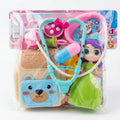 Doctor toy set in clear packaging: pink stethoscope, light-blue tools, and green gown figure