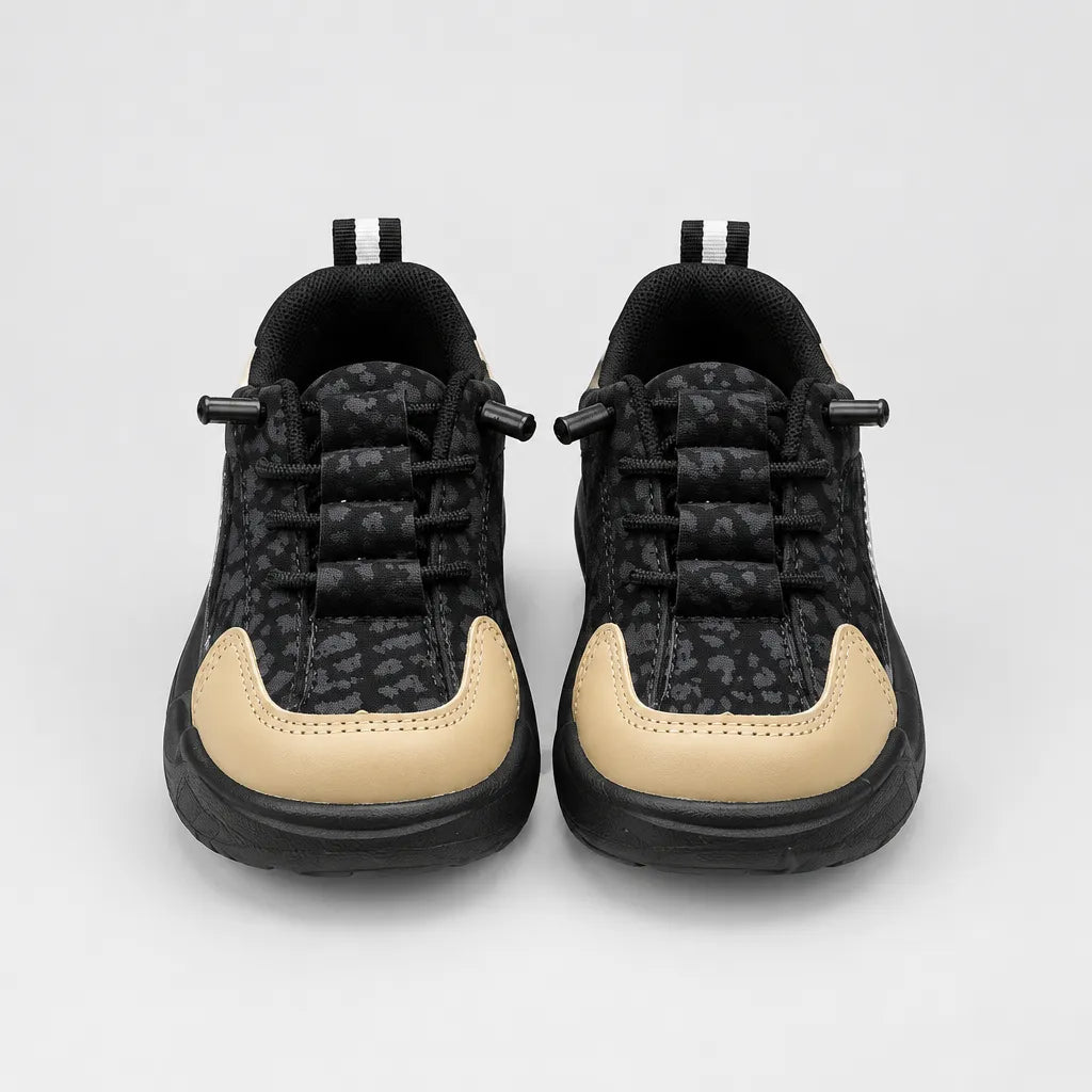 Black Trail kids sneaker with tan toe and heel panels, inner side view