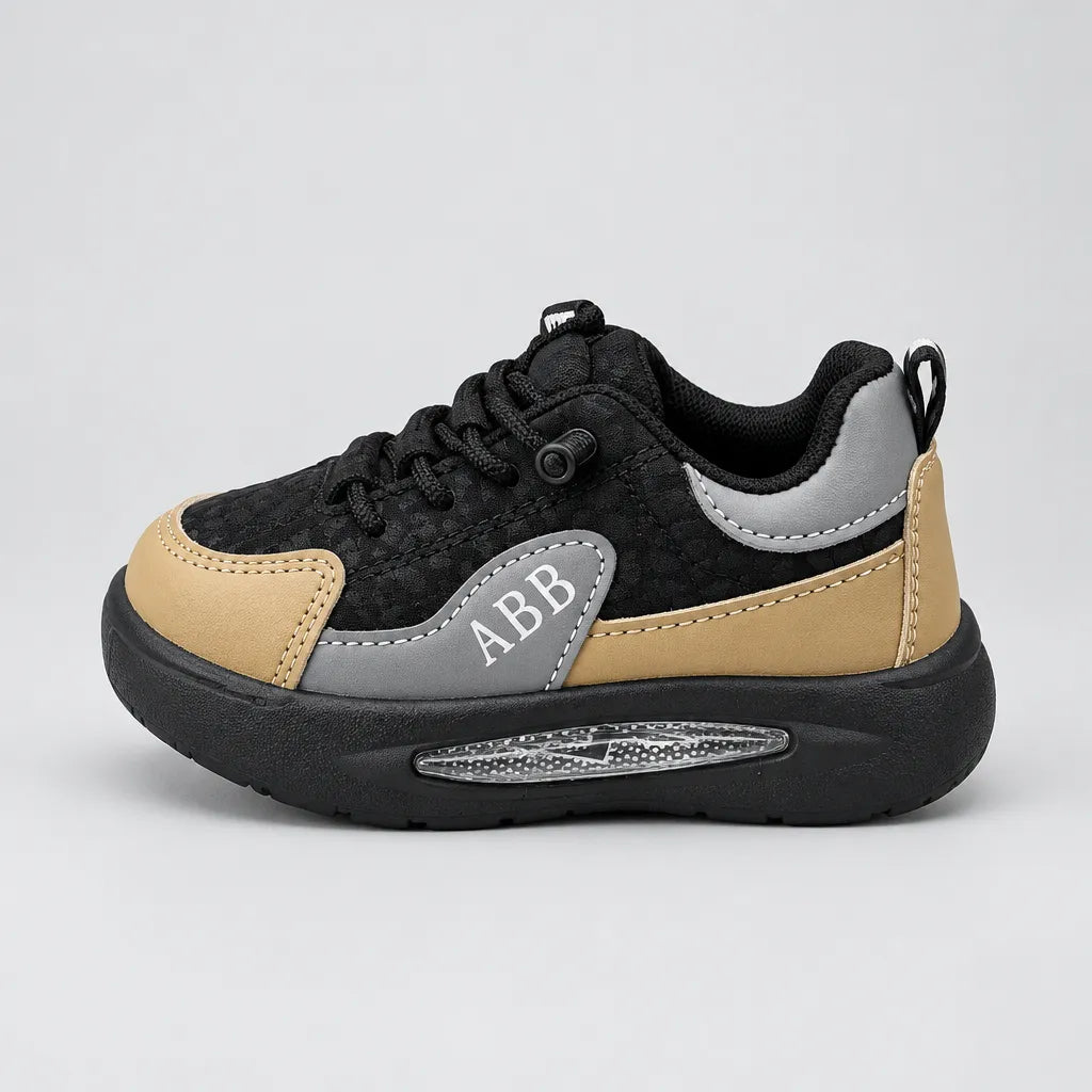 Pair of black Trail kids sneakers showing lace detailing and tan toe panels