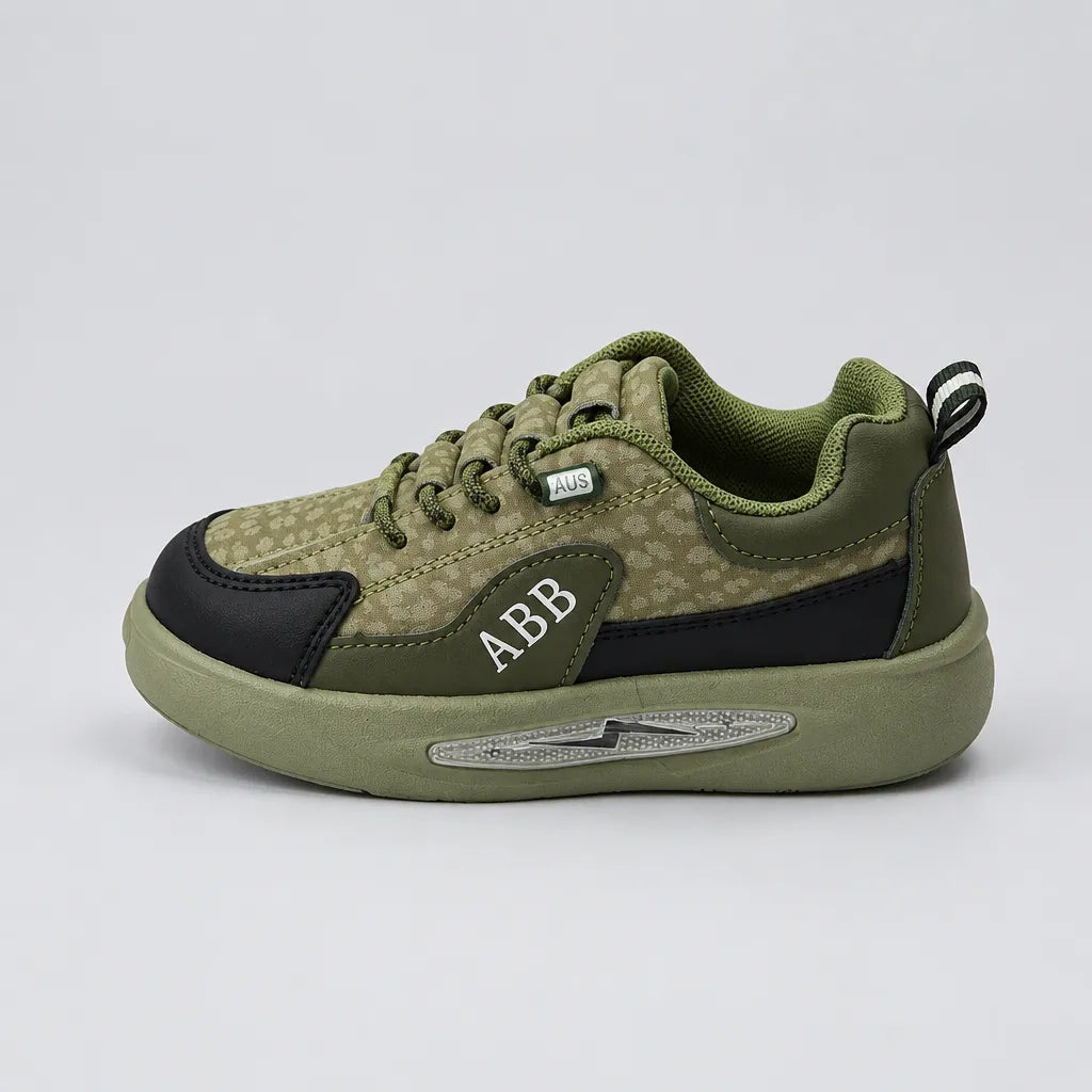 Green Trail kids sneaker showing dark toe panel and heel pull tab, inner side view