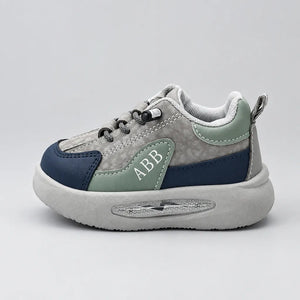 Grey-toned Trail kids sneaker listed as Beige, showing chunky light sole, inner side