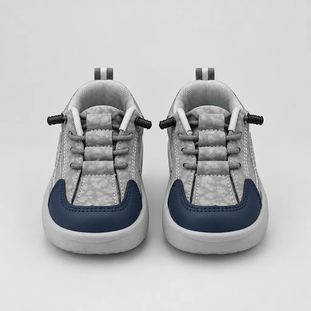 Front view of grey-toned Trail kids sneakers listed as Beige, with navy toe panels