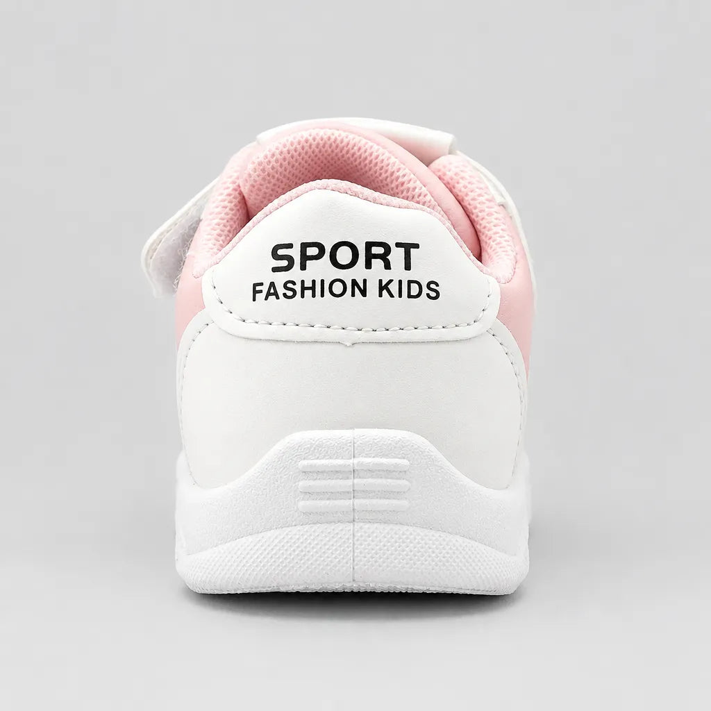Underside of a white kids’ sneaker showing the patterned outsole tread.