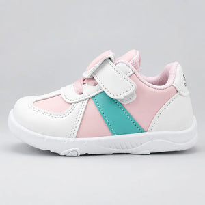 Side view of a pink and white kids’ sneaker with a turquoise stripe and hook-and-loop strap.