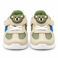 Alternate side view of a green and beige kids’ sneaker with blue accent stripe and white sole.