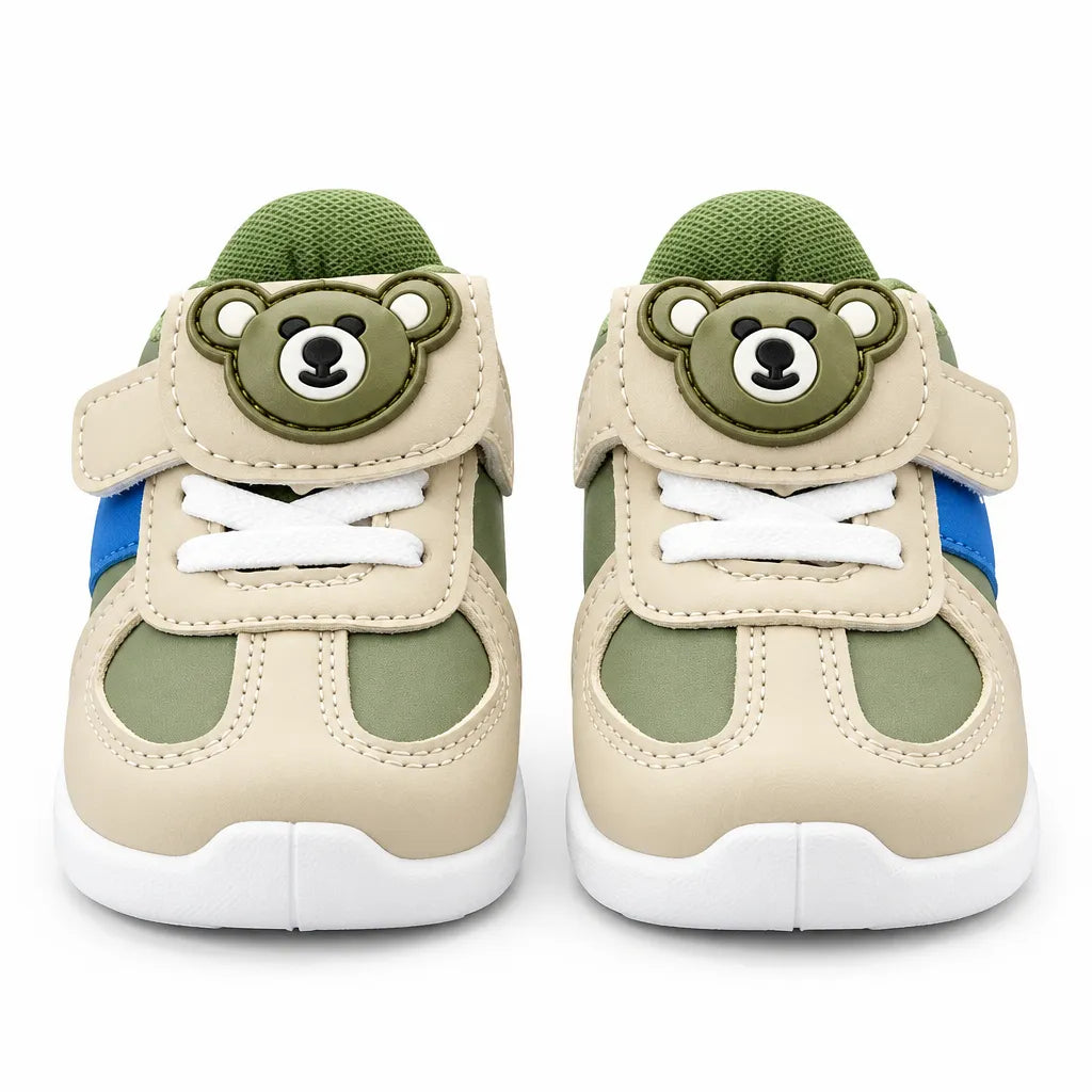 Alternate side view of a green and beige kids’ sneaker with blue accent stripe and white sole.