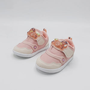Light pink kids' sneakers with bear appliques, white sole, and beige side panels