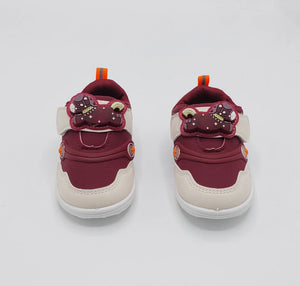 Angled view of pink Glow Bear kids shoe with bear-detail strap and white sole