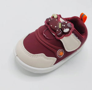 Angled view of deep burgundy Glow Bear kids shoe with bear-detail strap and white sole