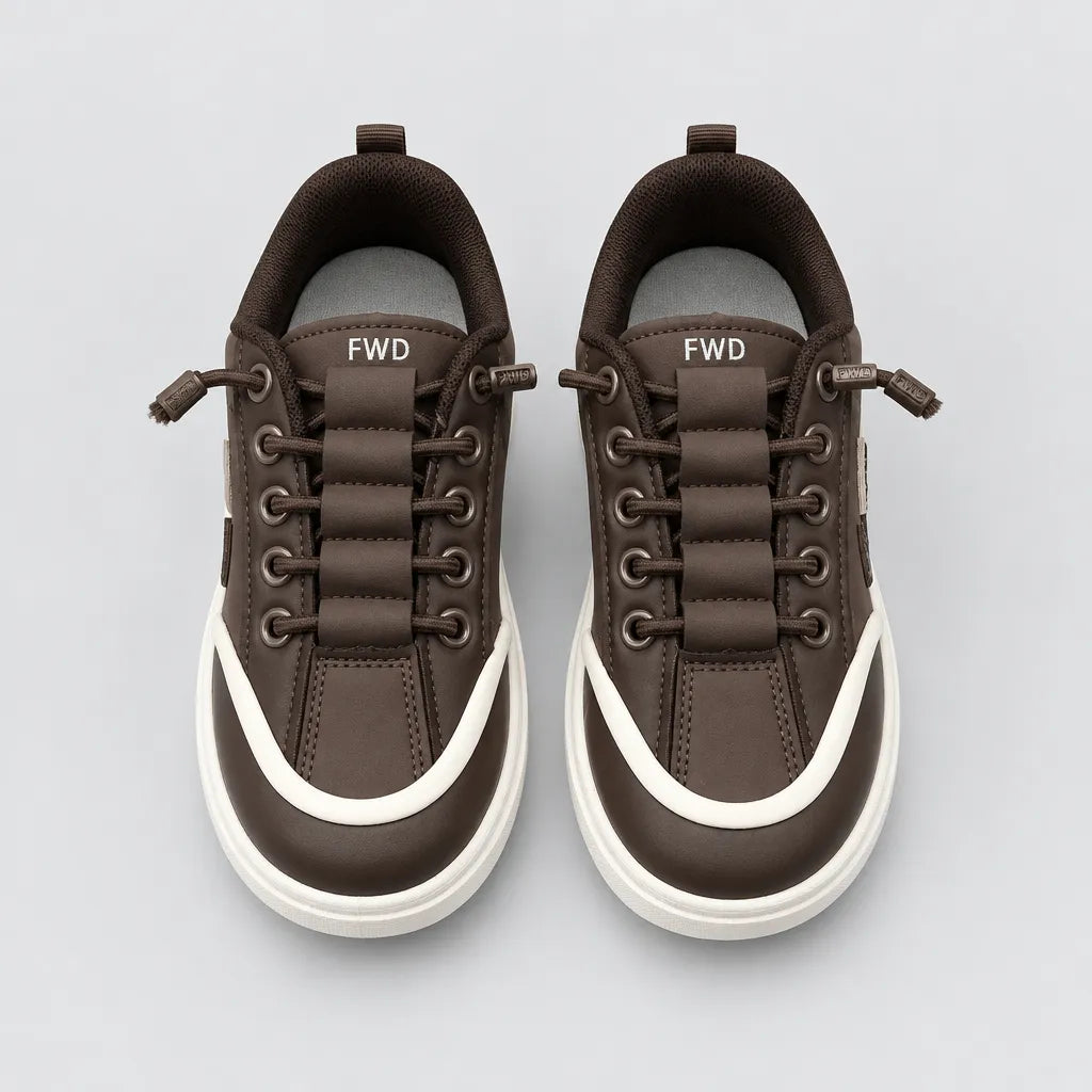 Inner side of Brown DuoTrim kids sneaker showing white trim and chunky sole