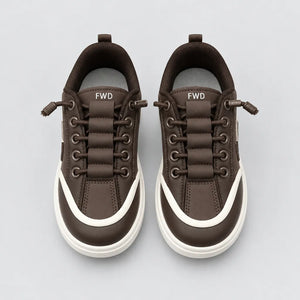 Inner side of Brown DuoTrim kids sneaker showing white trim and chunky sole