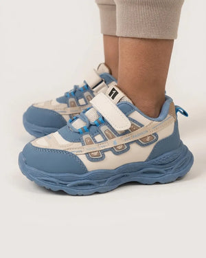 Maroon and pink kids chunky sneakers worn by a child, front view