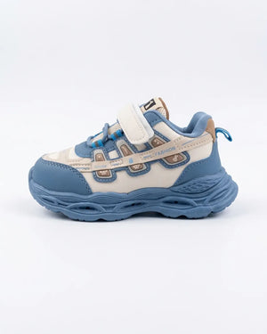 Beige kids chunky sneaker with mint accents, side view on a wooden background
