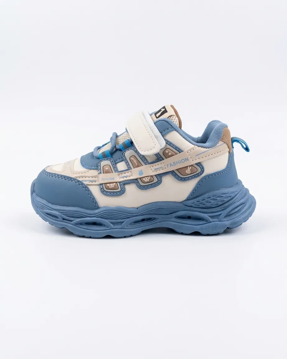 Beige kids chunky sneaker with mint accents, side view on a wooden background