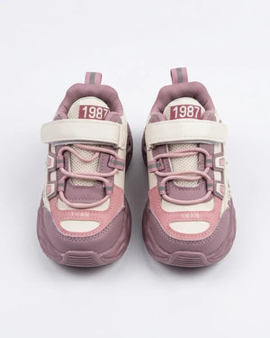 Blue and cream kids chunky sneakers worn by a child, front angle