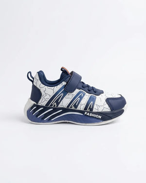 Side profile of navy and white kids strap sneaker with patterned upper and chunky navy sole