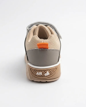 Angled view of beige and olive kids sneakers with hook-and-loop strap