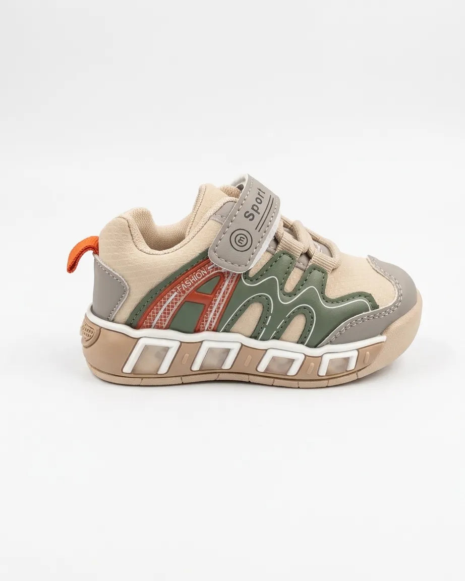 Side view of child wearing beige and olive kids sneakers