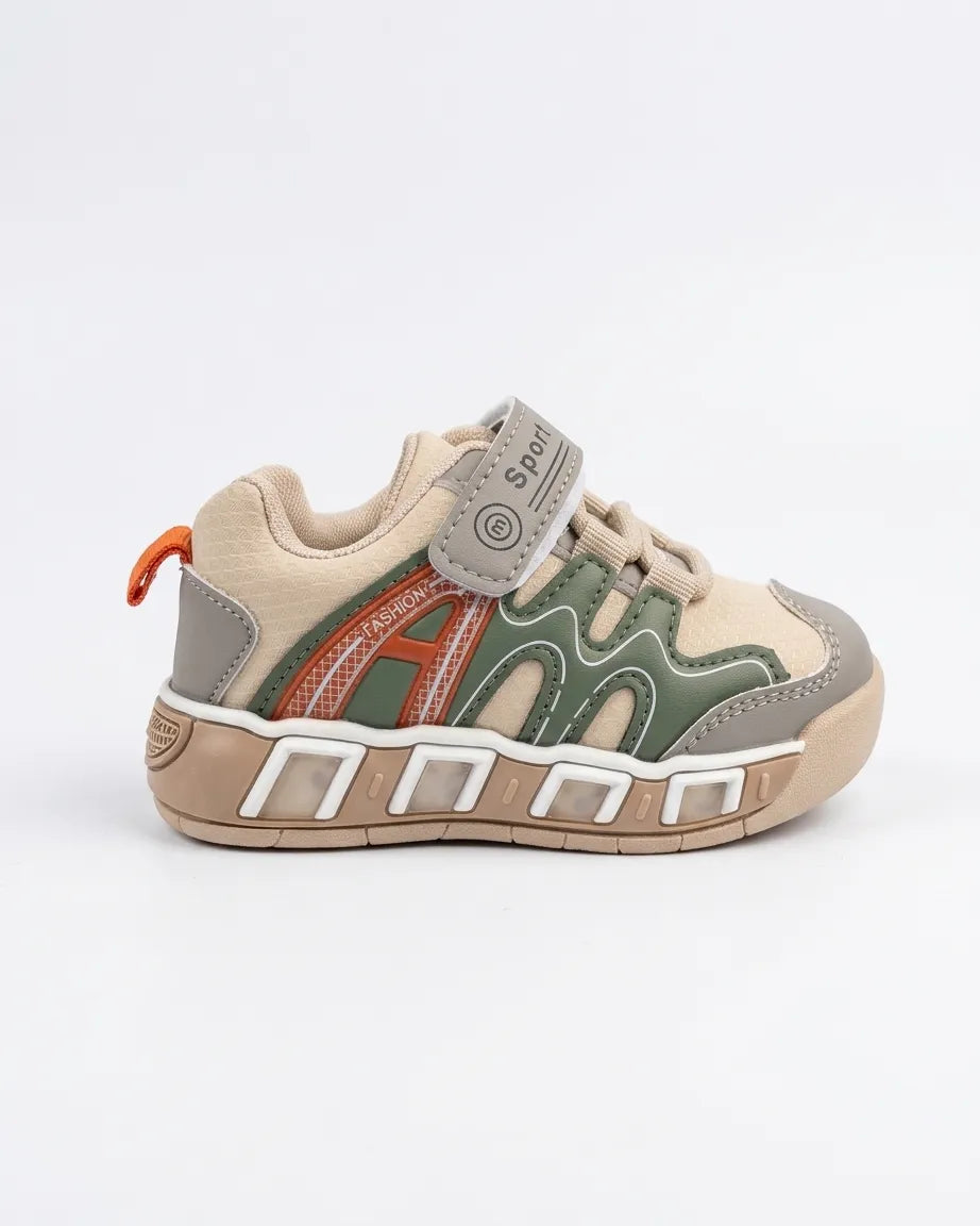 Beige and olive kids sneaker showing the chunky textured outsole