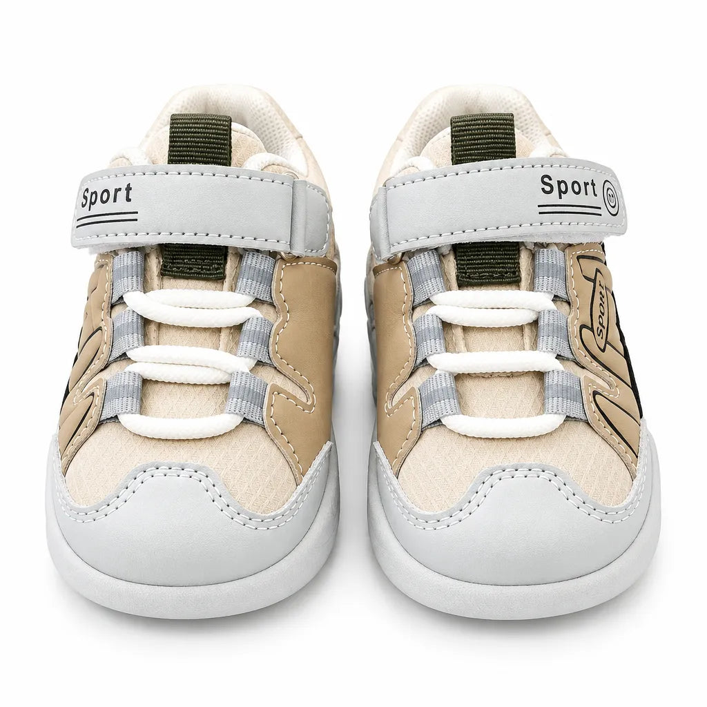 Side view of a beige and olive green kids sport sneaker with grey accents, hook-and-loop strap, lace-style detailing and chunky segmented sole