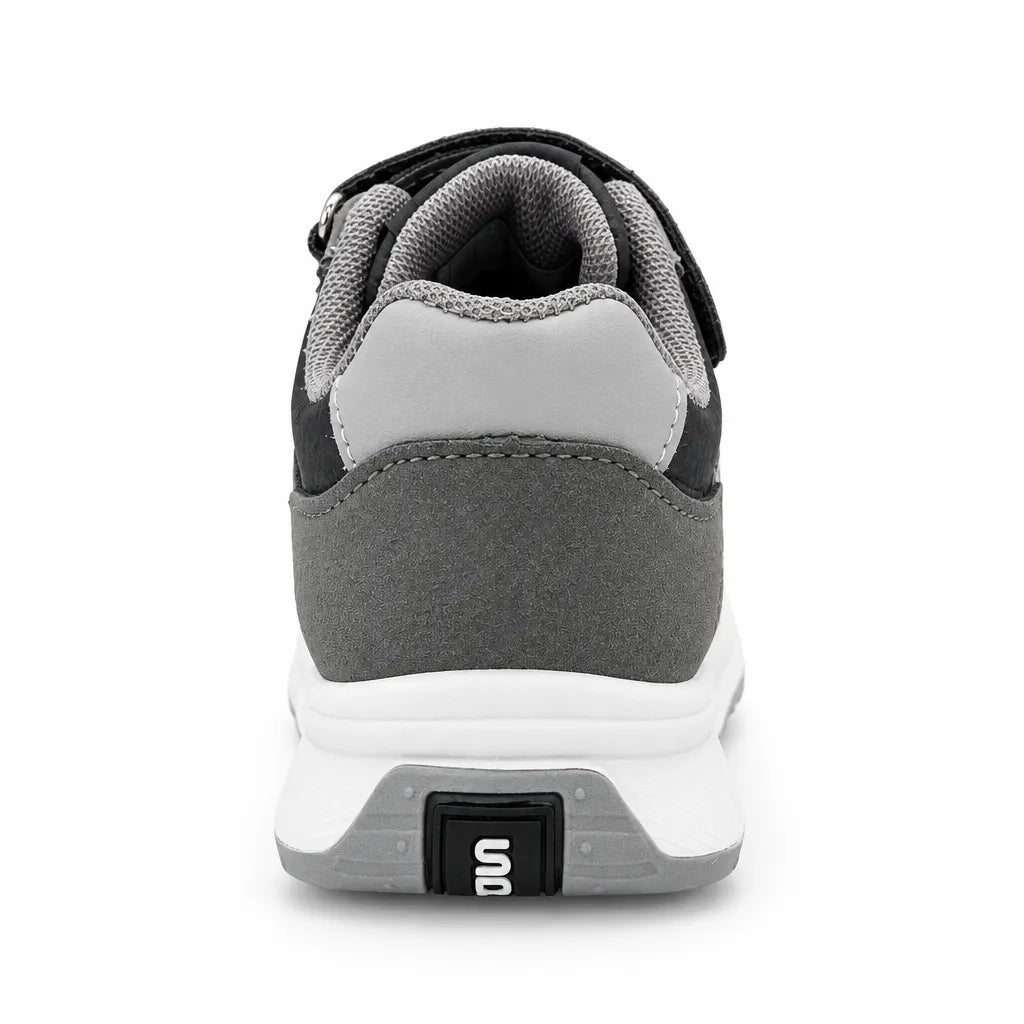 Side view of grey and black kids’ sneaker with three light stripes and a white sole