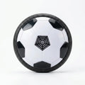 Hover soccer ball with textured black rim and white hex-panel design