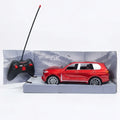 A red remote-controlled toy SUV displayed in its gray retail box, alongside a black handheld controller with a long antenna, on a clean white background.