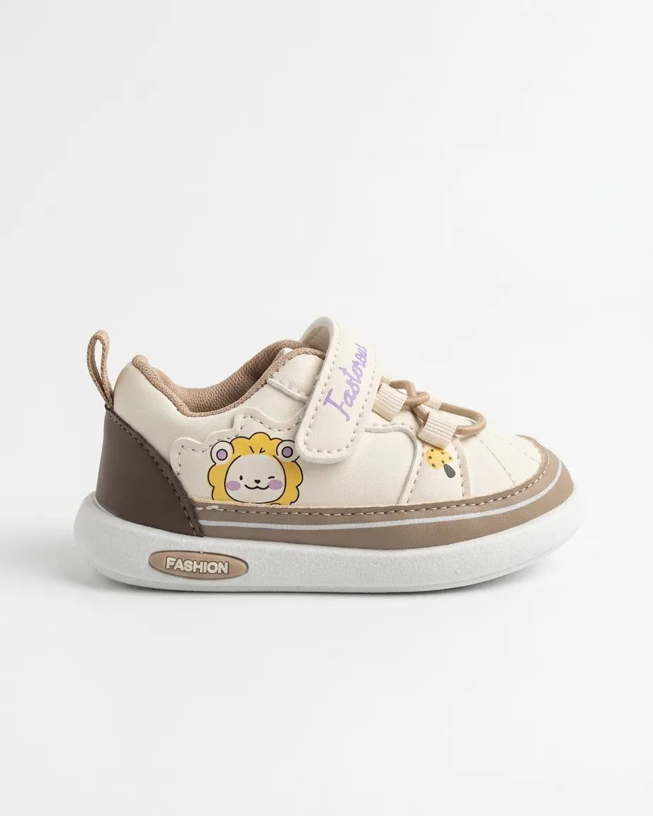 Child wearing pink and cream cartoon dinosaur sneakers with strap fastening
