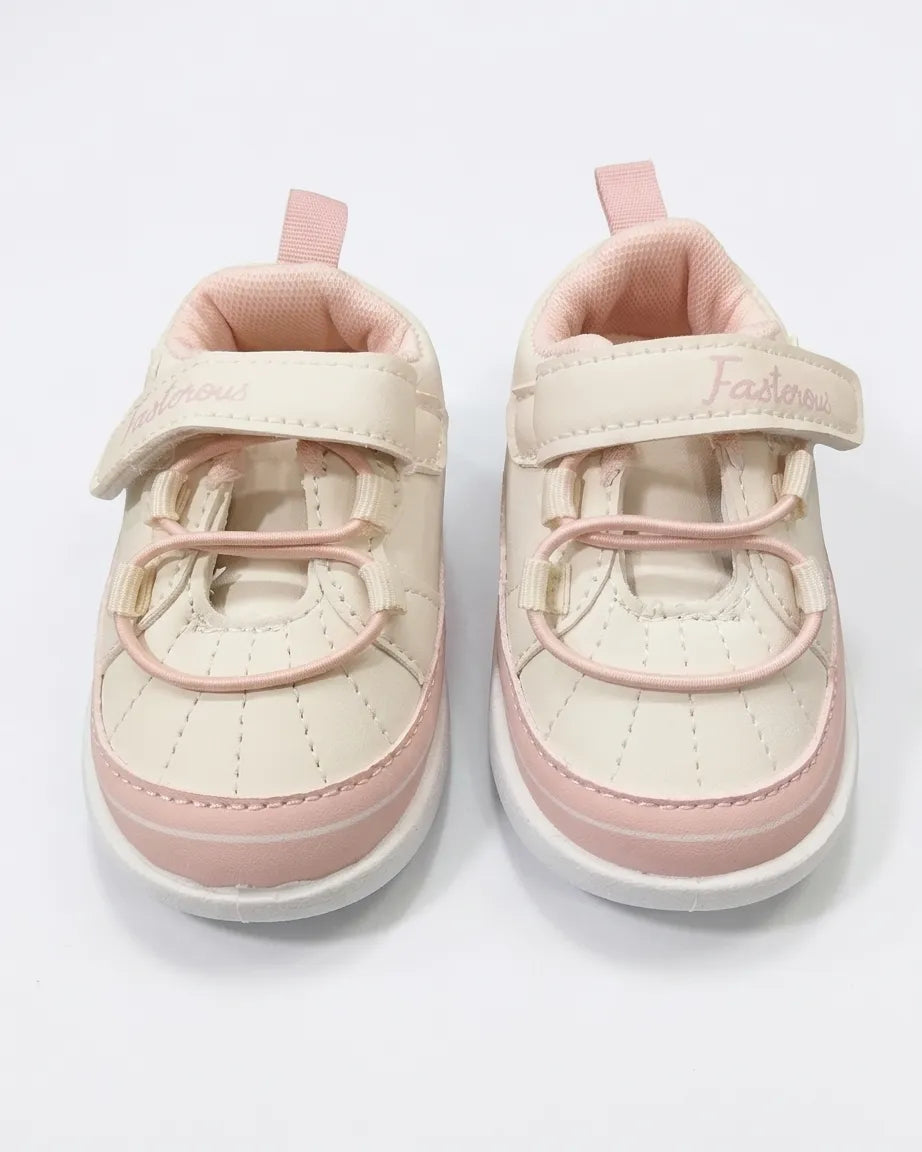 Side view of cream and tan kids cartoon sneakers with strap and character patch