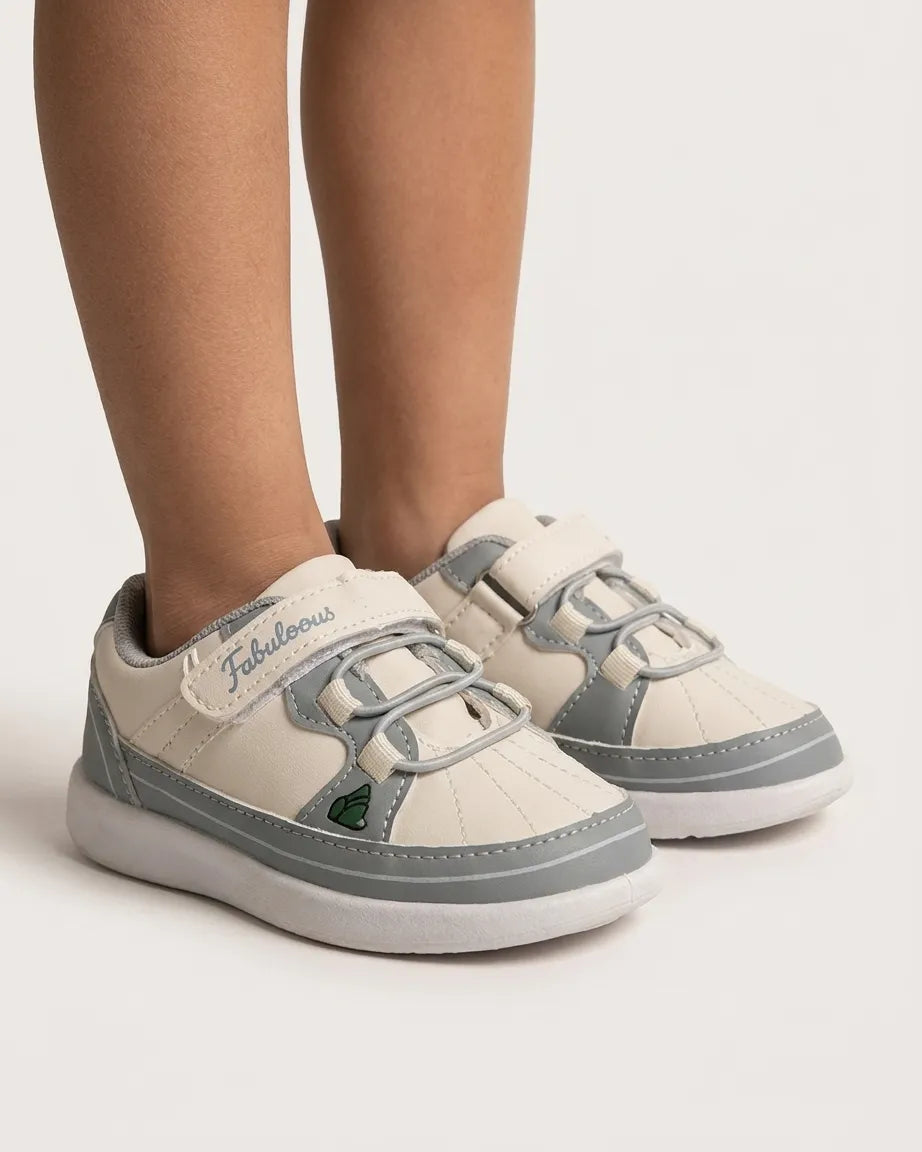 Side view of pink and cream cartoon sneakers for kids with strap fastening