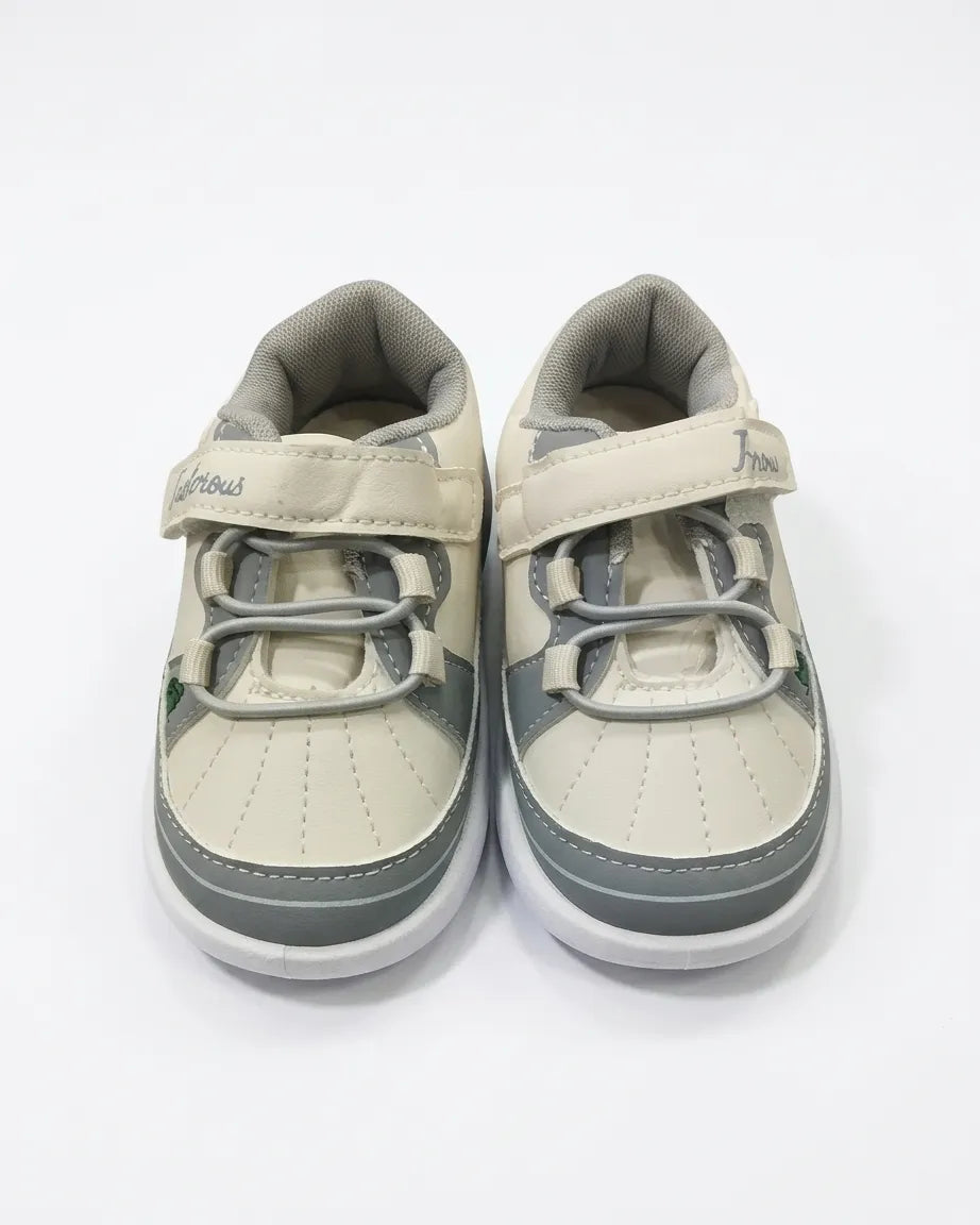 Side view of cream and grey cartoon sneakers for kids with strap and animal graphic