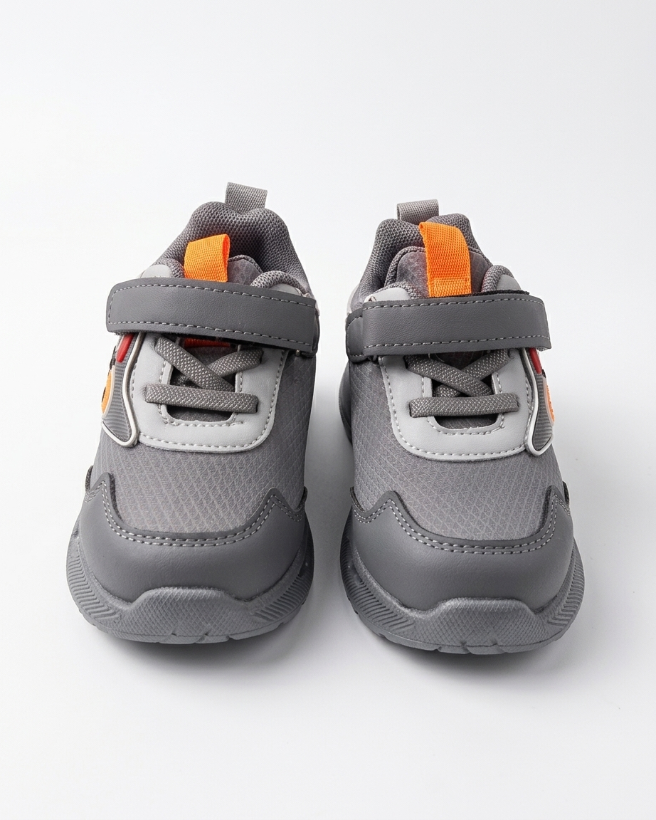 Front view of beige kids chunky sneakers with blue panels and straps