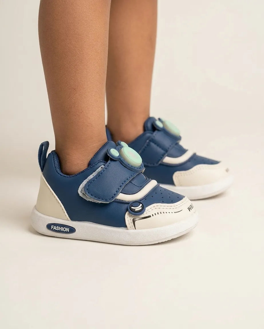Front view of blue cartoon strap kids sneakers with contrast toe