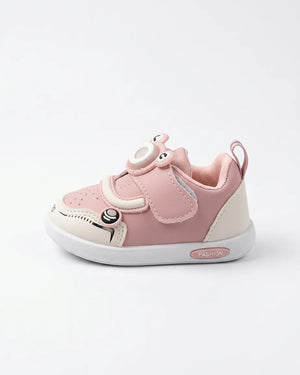 Angled side view of pink cartoon sneakers for kids
