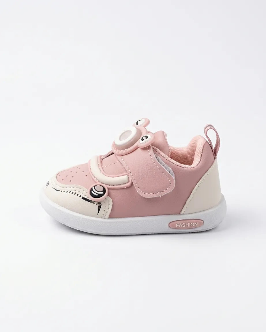 Angled side view of pink cartoon sneakers for kids