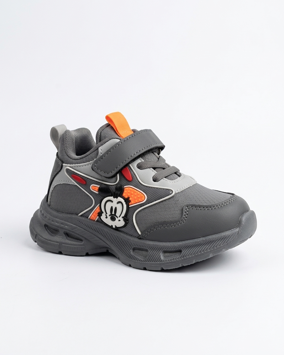Blue kids cartoon chunky sneakers with strap worn with casual trousers