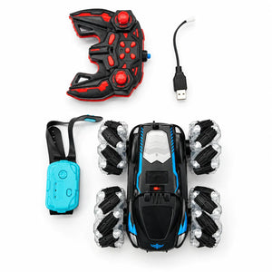 Black and blue four-wheel RC stunt car with red handheld remote, turquoise gesture watch and USB charging cable