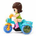 Front view of Stunt Tricycle Doll with green outfit, turquoise tricycle and blue wheels