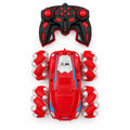 Red RC stunt car with blue accents, roller-style wheels and black-and-red handheld controller