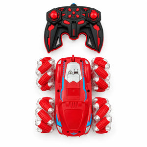 Red RC stunt car with blue accents, roller-style wheels and black-and-red handheld controller