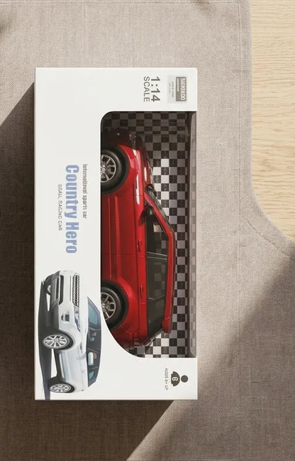 Red RC car in retail blister box, viewed from above on surface.
